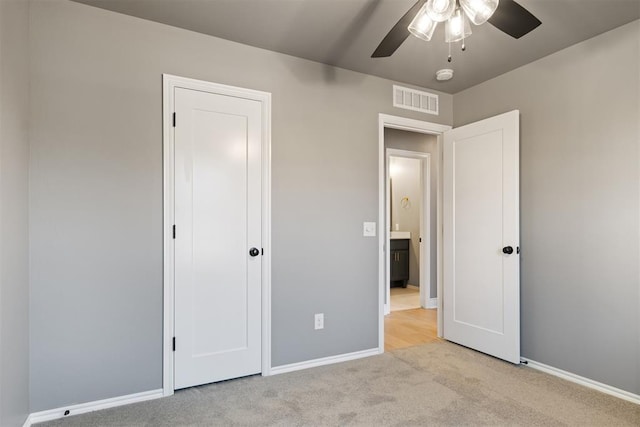 unfurnished bedroom with light carpet and ceiling fan