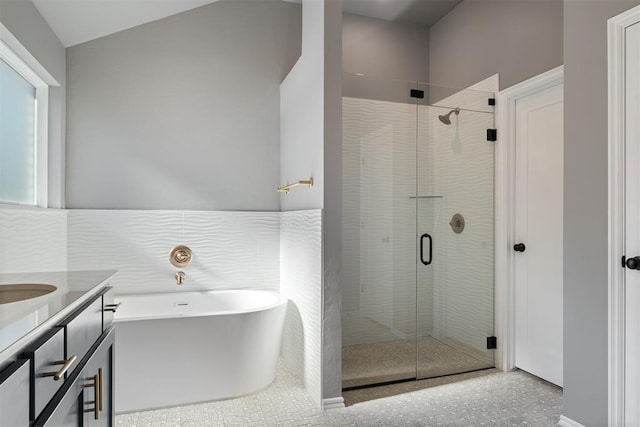 bathroom featuring vanity and independent shower and bath