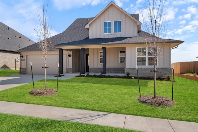 view of front of property with a porch, a front yard, and a garage