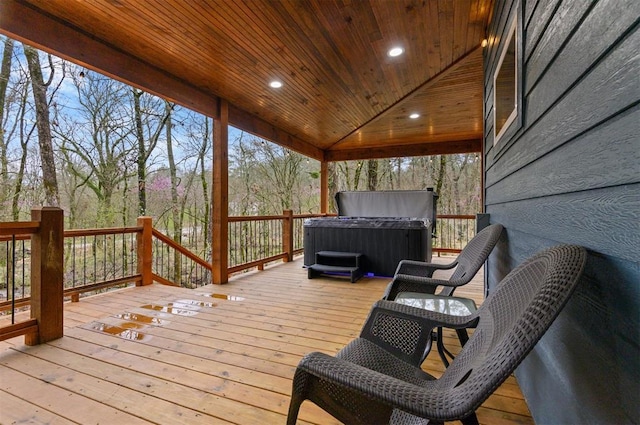 wooden terrace featuring a hot tub