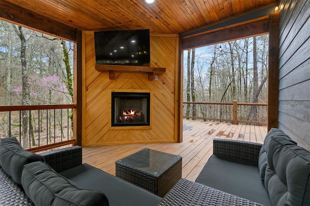 deck featuring an outdoor living space with a fireplace