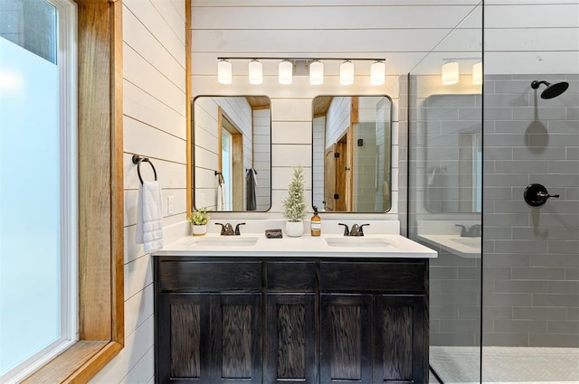 bathroom featuring wooden walls, vanity, and tiled shower