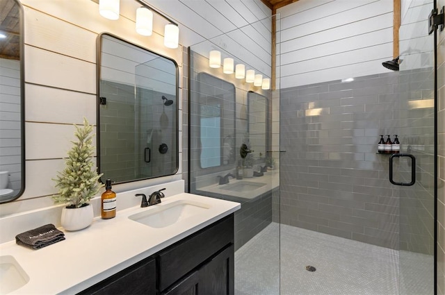 bathroom with vanity and a shower with shower door