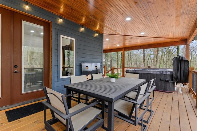 wooden deck with a hot tub