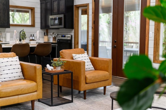 kitchen with french doors, black range with electric cooktop, and light hardwood / wood-style flooring