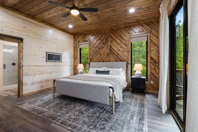 bedroom with ceiling fan, wooden walls, and dark hardwood / wood-style floors