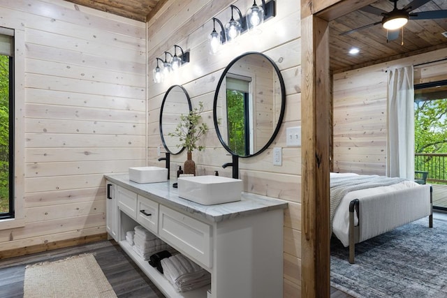 bathroom with wooden walls, wood-type flooring, and a wealth of natural light