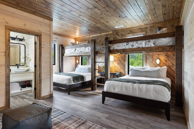 bedroom with wood walls, wood-type flooring, sink, and wooden ceiling