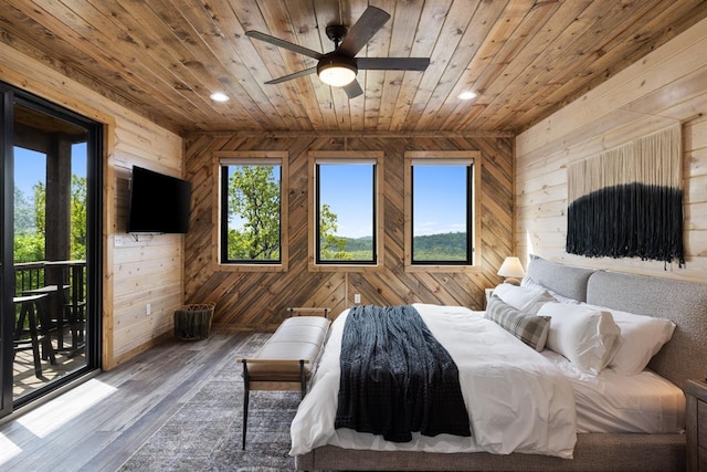 bedroom featuring ceiling fan, hardwood / wood-style floors, access to outside, wooden walls, and wood ceiling