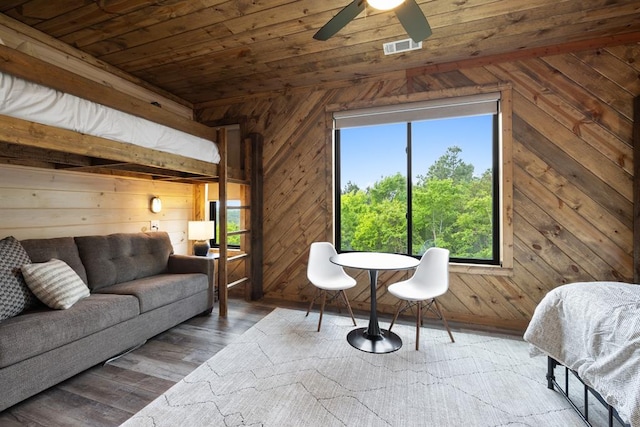 interior space with wood-type flooring, wooden ceiling, and wood walls