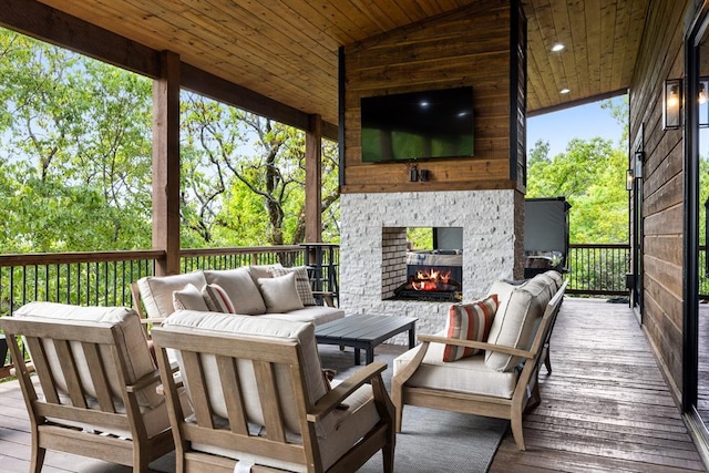 wooden deck featuring an outdoor living space with a fireplace