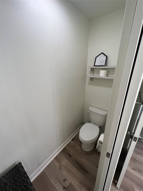 bathroom featuring toilet and hardwood / wood-style flooring