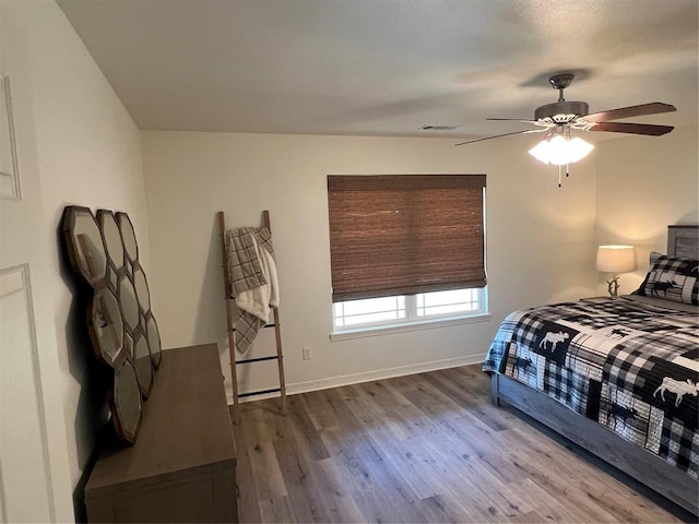 bedroom featuring hardwood / wood-style flooring and ceiling fan