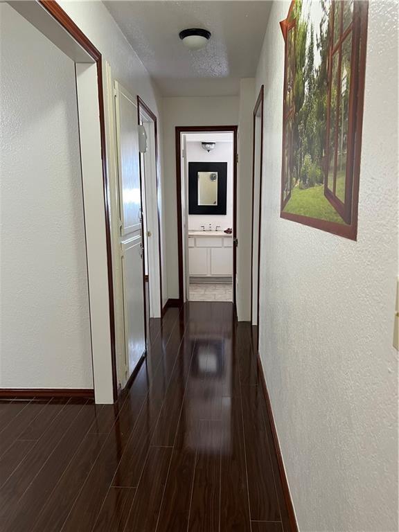 hall with dark hardwood / wood-style flooring