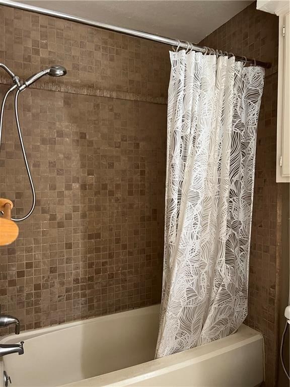 bathroom with shower / bath combination with curtain