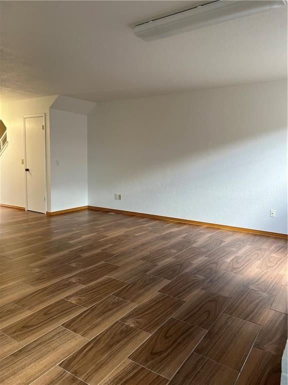 unfurnished room featuring dark wood-type flooring