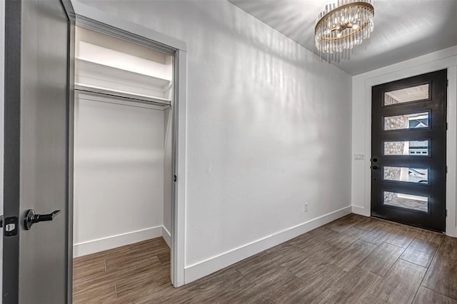 entryway featuring a chandelier and dark hardwood / wood-style floors