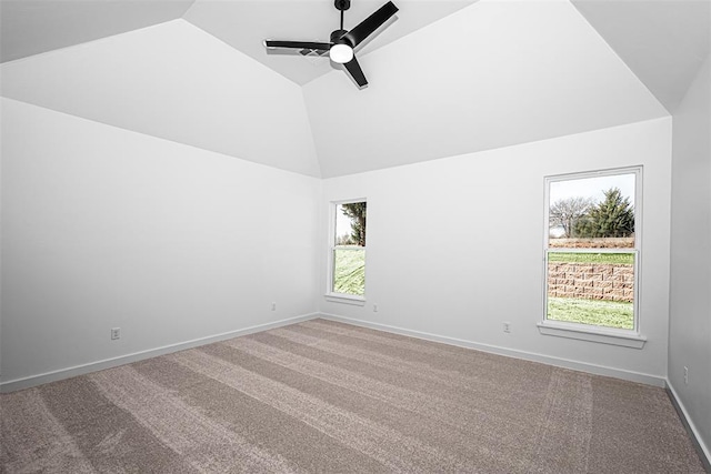 carpeted spare room featuring ceiling fan and vaulted ceiling