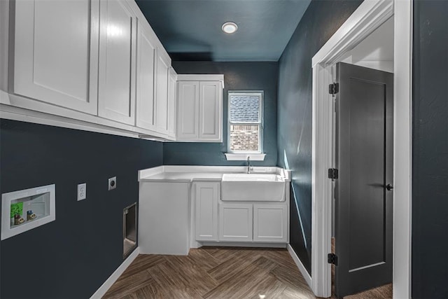 clothes washing area featuring cabinets, dark parquet flooring, sink, hookup for a washing machine, and hookup for an electric dryer