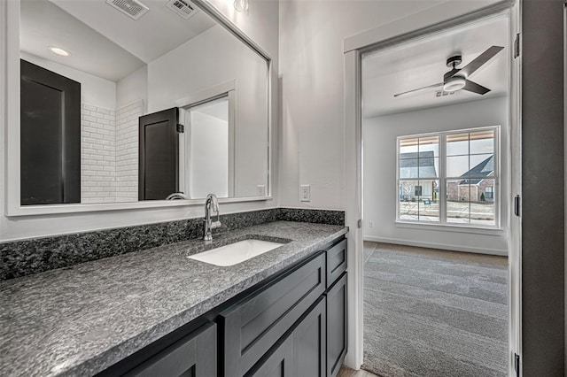 bathroom featuring ceiling fan and vanity