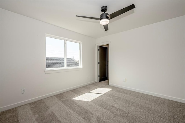 spare room featuring ceiling fan and light carpet