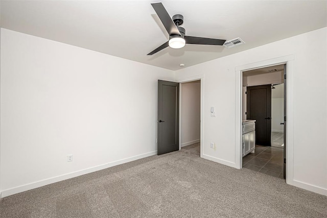 unfurnished bedroom with ceiling fan and carpet floors