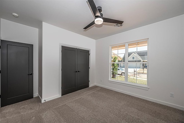 unfurnished bedroom featuring carpet flooring, a closet, and ceiling fan