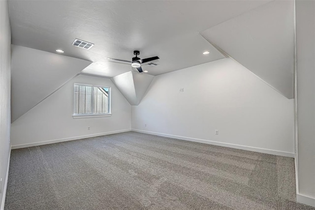 additional living space featuring carpet, vaulted ceiling, and ceiling fan