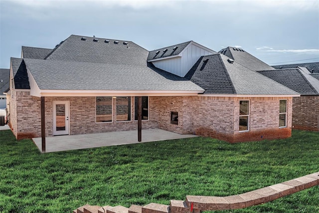 rear view of property featuring a patio and a lawn