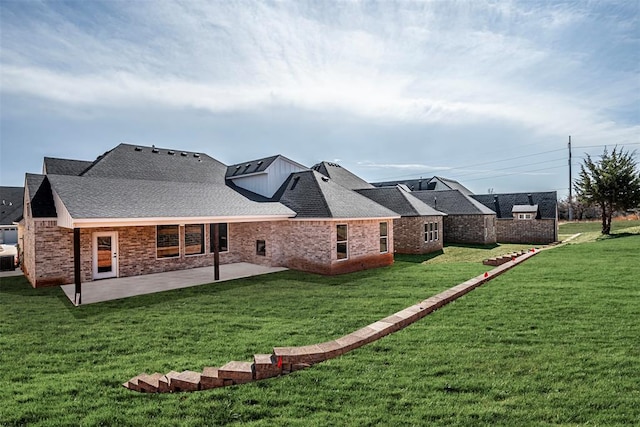 rear view of property with a lawn and a patio area