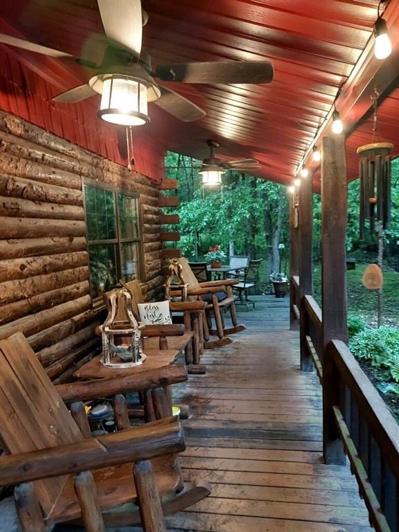 wooden deck featuring ceiling fan