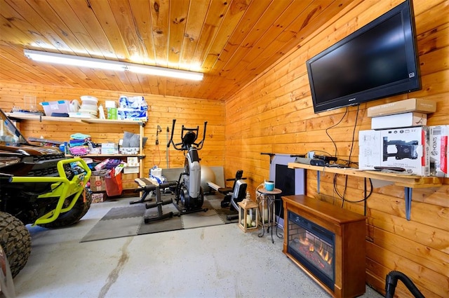 exercise room featuring wood ceiling and wooden walls