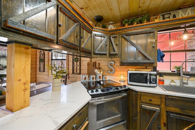 kitchen with wooden walls, sink, wood ceiling, and appliances with stainless steel finishes