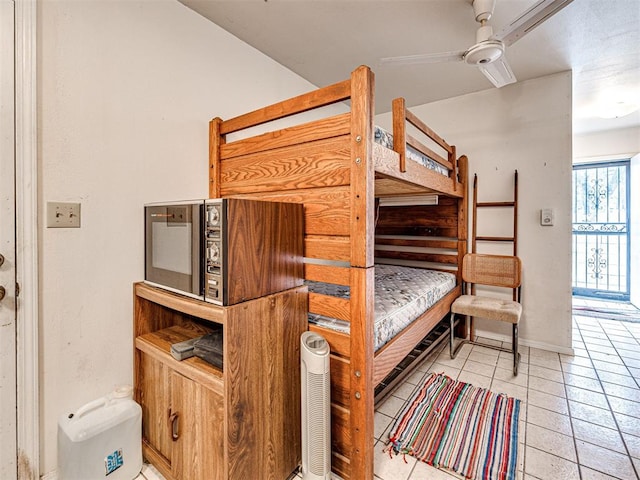 tiled bedroom with ceiling fan