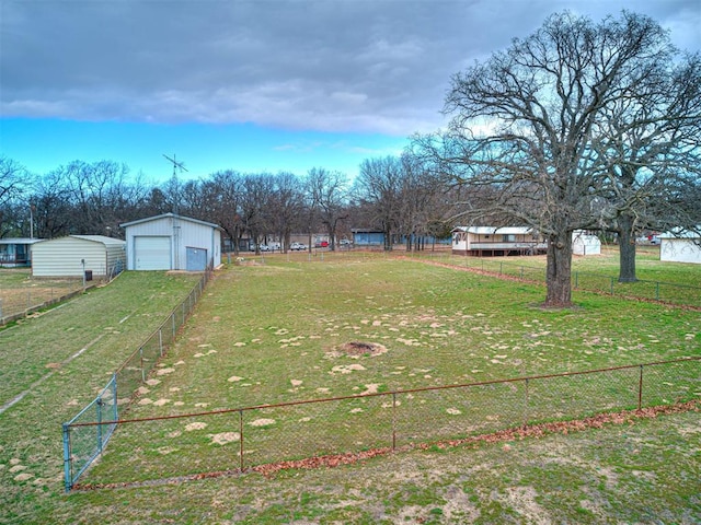 view of yard featuring a garage and an outbuilding