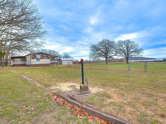 view of yard with a rural view and an outbuilding