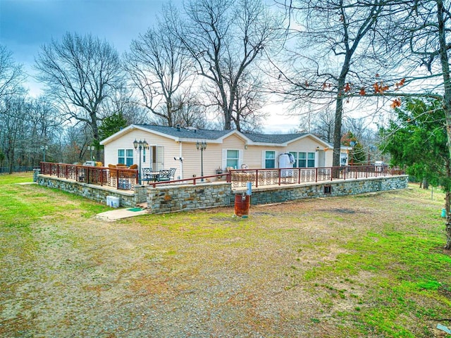 rear view of property with a yard