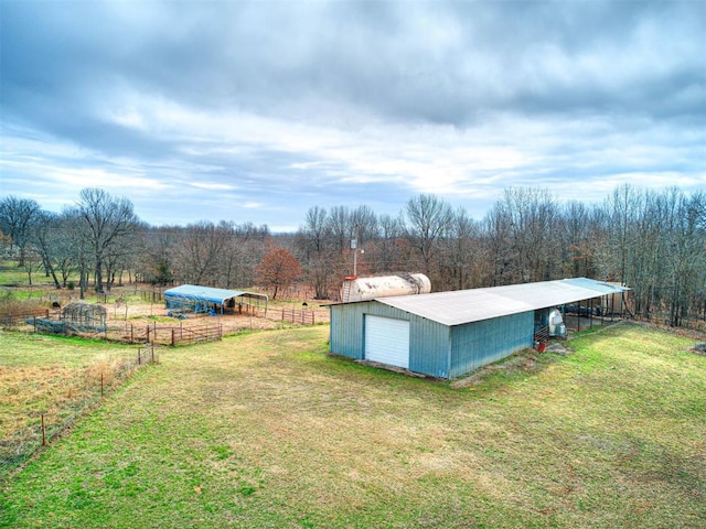 view of yard featuring a rural view and an outdoor structure