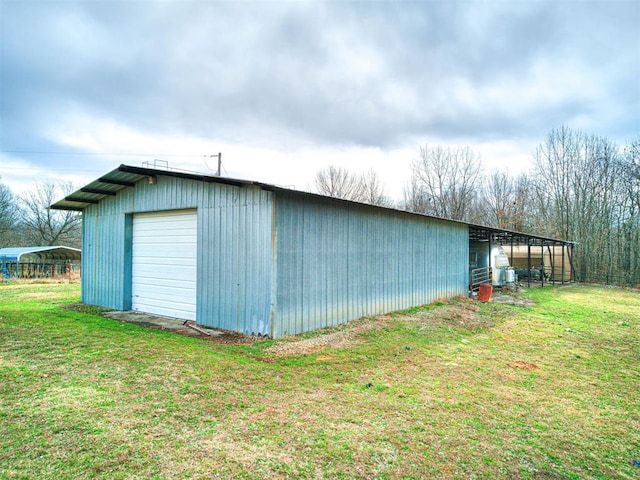 view of outdoor structure with a yard and a garage