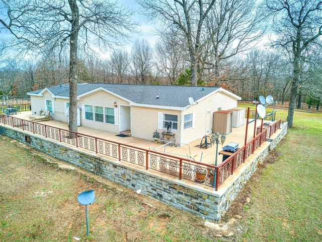 back of house featuring a yard and a deck