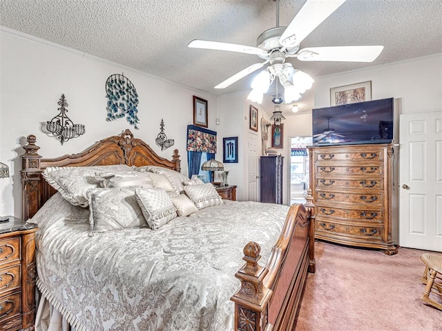 bedroom featuring carpet flooring, ceiling fan, a textured ceiling, and ornamental molding