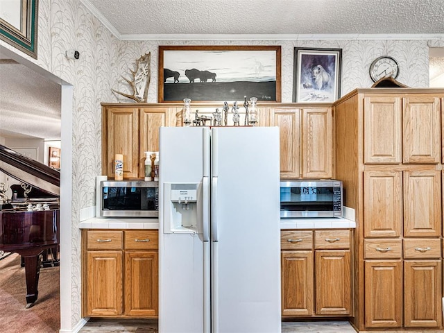 kitchen with a textured ceiling, light wood-type flooring, white fridge with ice dispenser, and ornamental molding