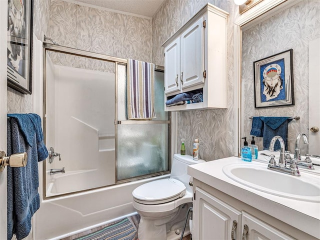 full bathroom with vanity, toilet, and shower / bath combination with glass door