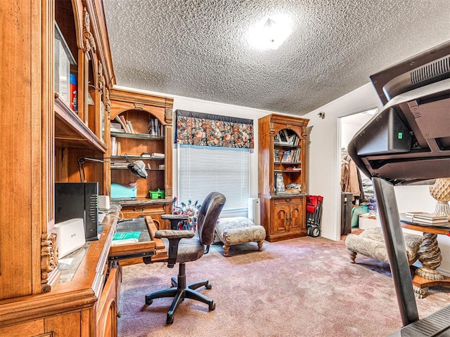 carpeted home office featuring a textured ceiling