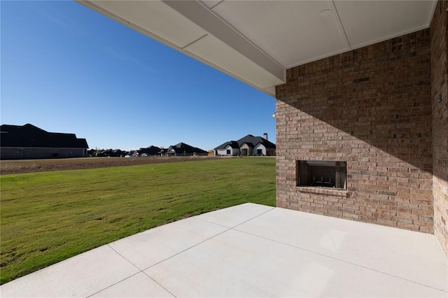 view of patio with an outdoor brick fireplace