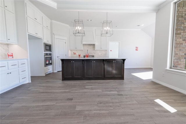 kitchen featuring white cabinetry, a kitchen island with sink, appliances with stainless steel finishes, and light hardwood / wood-style flooring