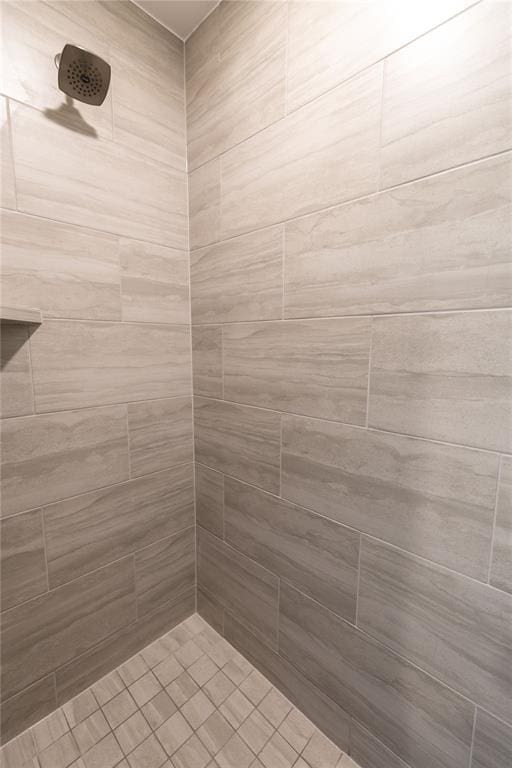 bathroom with a tile shower