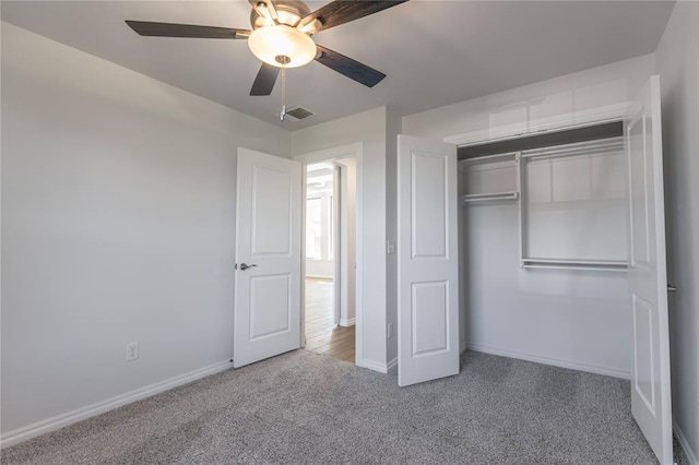 unfurnished bedroom featuring carpet flooring, a closet, and ceiling fan