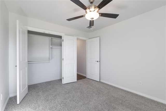 unfurnished bedroom featuring ceiling fan, a closet, and light colored carpet