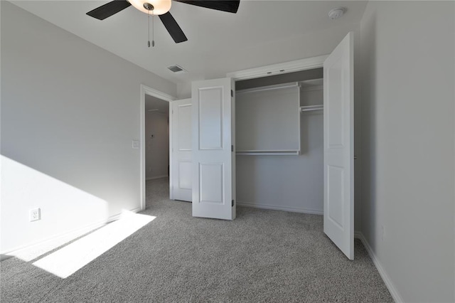 unfurnished bedroom featuring ceiling fan, light colored carpet, and a closet